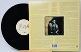 Vinyl record with cover featuring a black and white portrait and text