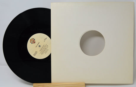 Paul Simon 'You Can Call Me Al' 12-inch vinyl record partially outside its original white sleeve