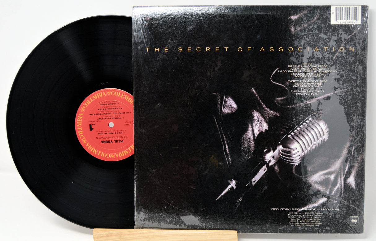Vinyl record with a cover featuring a leather jacket and a microphone, titled 'The Secret of Association'.