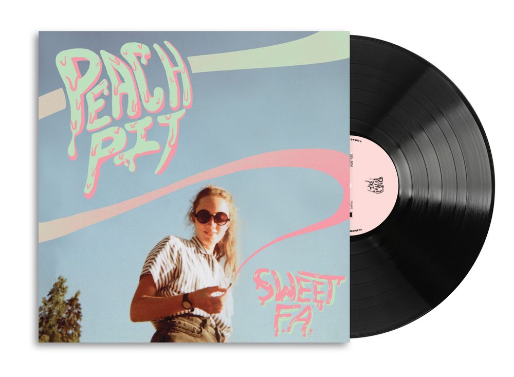 A vinyl record partially pulled from its sleeve, showing the album cover art for 'Sweet FA.' by Peach Pit.
