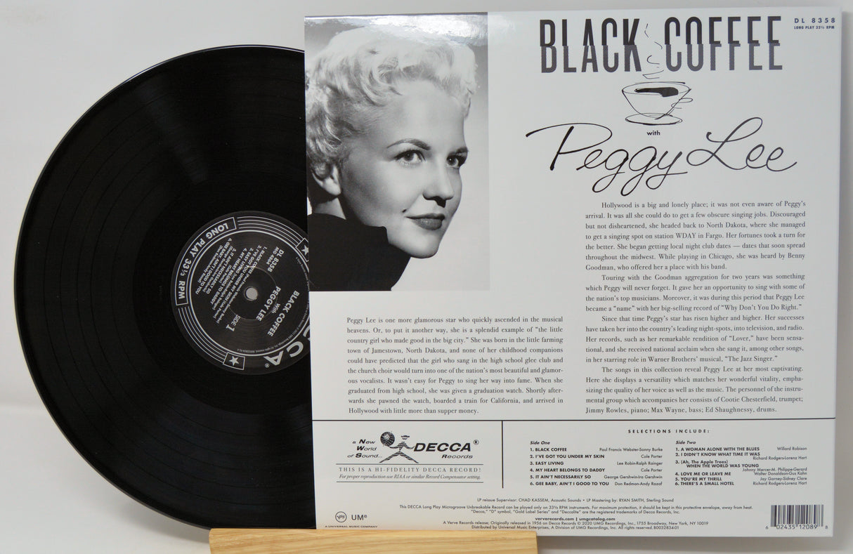 Peggy Lee 'Black Coffee' vinyl record album shown with the black record partially pulled from its printed outer sleeve, which features a portrait photo and track listing text.