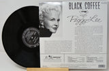 Peggy Lee 'Black Coffee' vinyl record album shown with the black record partially pulled from its printed outer sleeve, which features a portrait photo and track listing text.