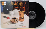 Vinyl record album 'Black Coffee with Peggy Lee' on Decca, showing the printed cover in front of the black vinyl record on a stand.