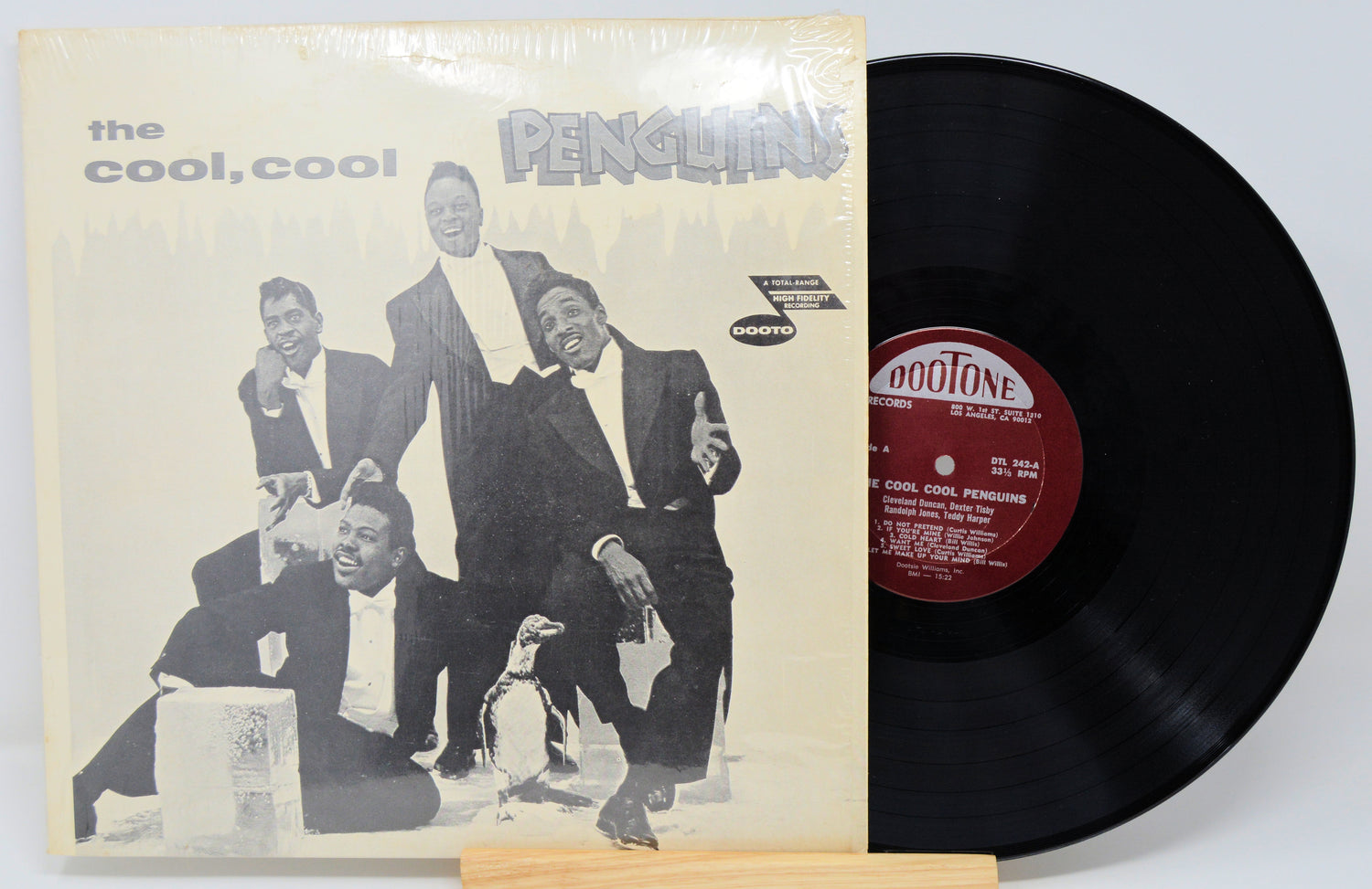 Vinyl record with cover featuring a group of people and penguins, labeled 'The Cool, Cool Penguins'.