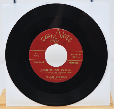 7-inch vinyl record with red label on a white background
