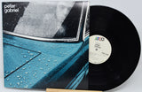Vinyl record with cover featuring a car window with raindrops and 'Peter Gabriel' branding.
