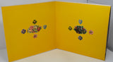 Yellow card with floral designs on a white background