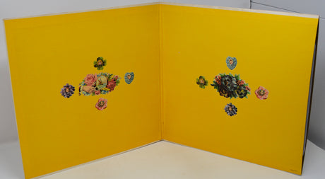 Yellow card with floral designs on a white background