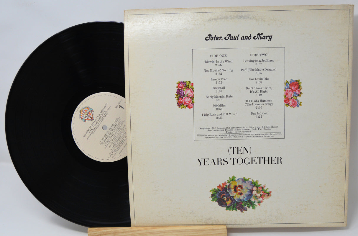 Vinyl record and cover with floral design and text on a white background