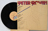 Peter Rowan 'With Me And The Red Hot Peppers' vinyl record LP, showing the black record partially pulled from its tan cardboard sleeve with red and blue title text.