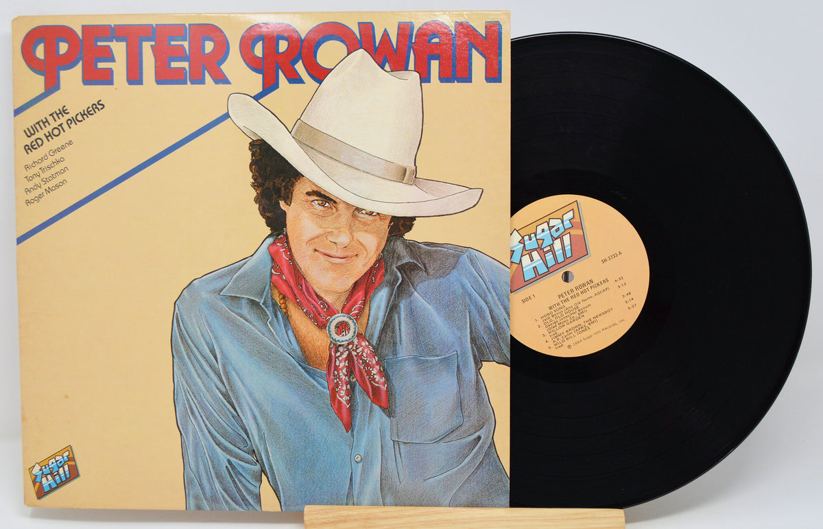 Peter Rowan 'South of the Red Hot Horses' vinyl record LP with its illustrated cover jacket and a partially visible black record on a light gray background.