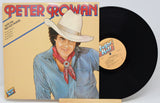 Peter Rowan 'South of the Red Hot Horses' vinyl record LP with its illustrated cover jacket and a partially visible black record on a light gray background.
