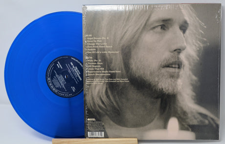 Blue vinyl record and its cover featuring a portrait of a person.
