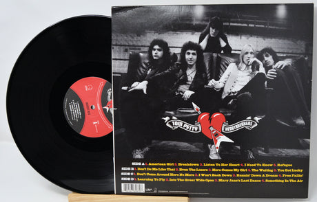Vinyl record with a black and white photo cover featuring a band and album details.