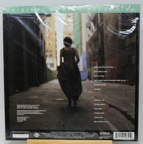 Back cover of a vinyl record sleeve for Sam's Club Original Master Recordings, featuring a dark street scene with a person walking away, tracklist text on the right, and a barcode at the bottom.