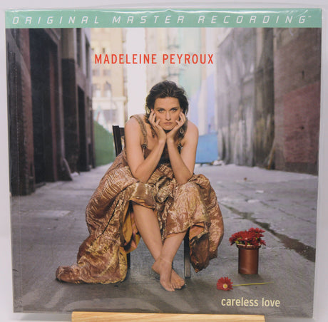Madeleine Peyroux 'Careless Love' original master recording vinyl LP cover, sealed in its plastic shrink wrap, displayed on a wooden stand against a light gray background.