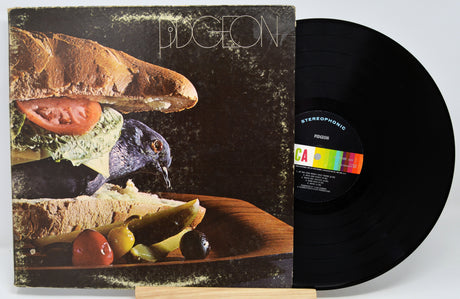 Vinyl record with a colorful label and a cover featuring food and a bird.