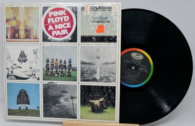 Vinyl record with a colorful label and a display case featuring album cover images.