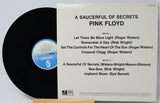 Vinyl record with cover displaying tracklist of Pink Floyd's 'A Saucerful of Secrets'.