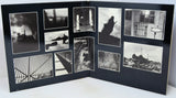 An open black photo album or book spread, displaying multiple black-and-white photographic prints arranged in a collage layout on the interior pages.