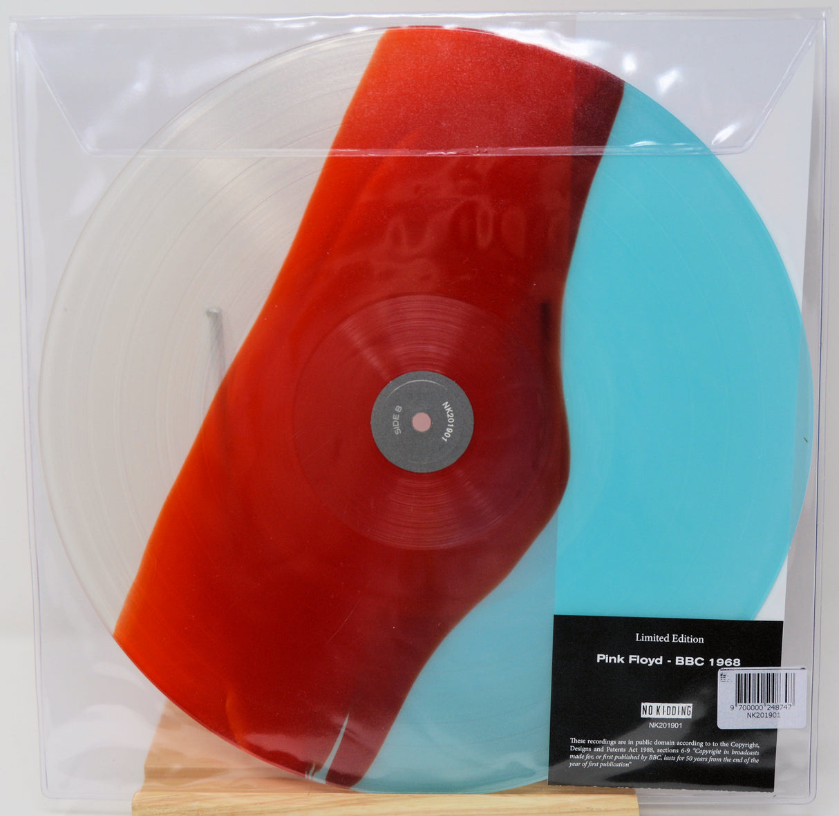 Pink Floyd 'BBC 1001' vinyl record in a clear plastic slipcase, featuring a translucent white record with a large red and turquoise color-blocked section, plus a black limited edition label.