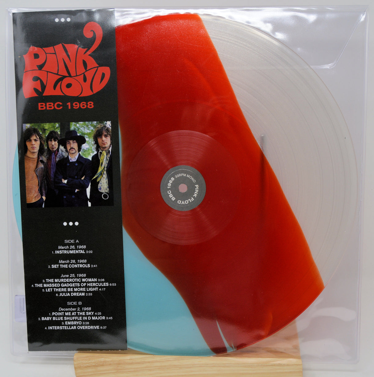Pink Floyd 'The Who Cried' 1968 double vinyl record in its original gatefold paper sleeve, featuring a translucent tri-color disc split between red, pale blue, and white, inside a clear plastic protective case.