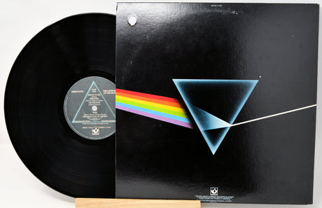 Vinyl record with a black cover featuring a blue triangle and rainbow, on a white background.