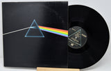 Vinyl record with 'The Dark Side of the Moon' album cover featuring a triangle and rainbow.