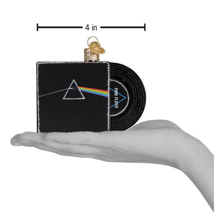 Hand holding a Pink Floyd Dark Side of the Moon record ornament measuring 4 inches