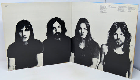 Album cover with black and white portraits of four band members on a beige background