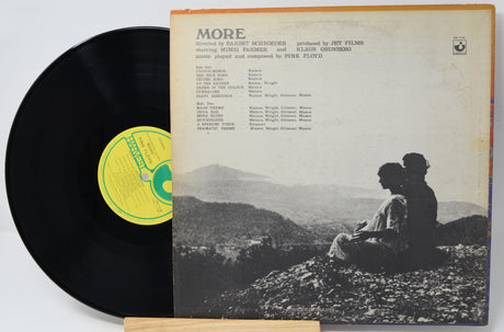 Vinyl record with cover featuring a couple on a mountain, text, and a yellow label.