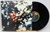 Vinyl record with a colorful cover featuring abstract designs on a white background