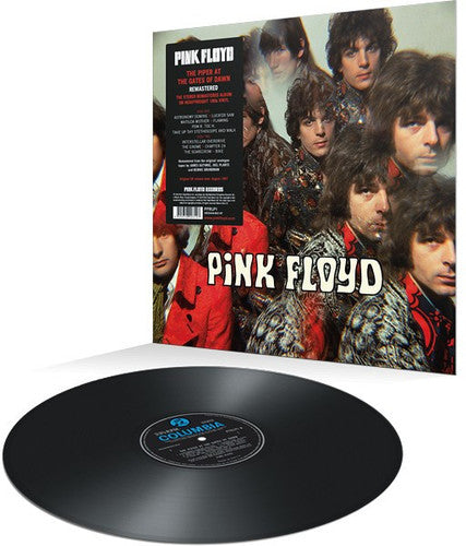 A vinyl record of Pink Floyd's album 'Piper At The Gates of Dawn'. The cover features a photo of the band members with a colorful, psychedelic filter.