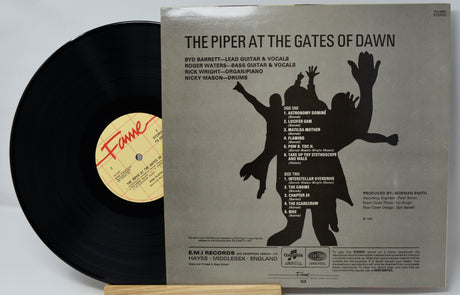 Vinyl record with its cover displaying 'The Piper at the Gates of Dawn' by Pink Floyd.