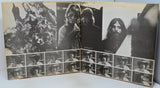 An open vintage photo album or binder showing multiple black-and-white portrait photographs arranged in a collage layout, photographed against a light neutral background.