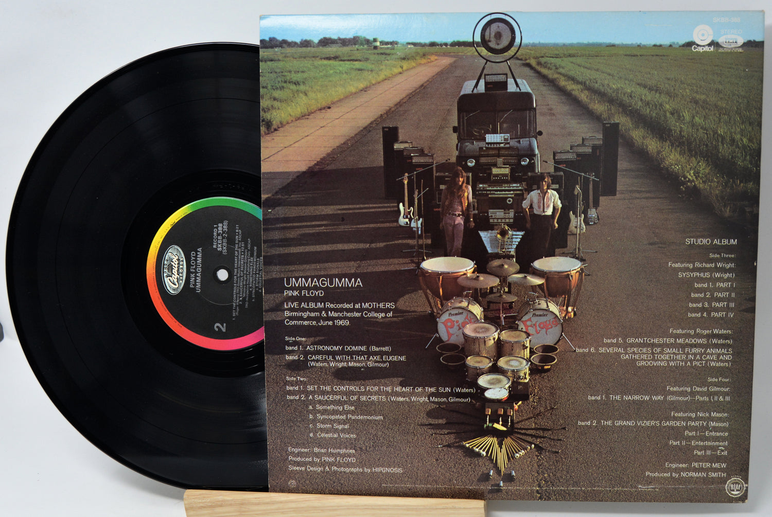 Vinyl record with a cover featuring a truck and drums on a road.