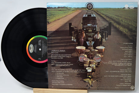 Vinyl record with a cover featuring a truck and drums on a road.