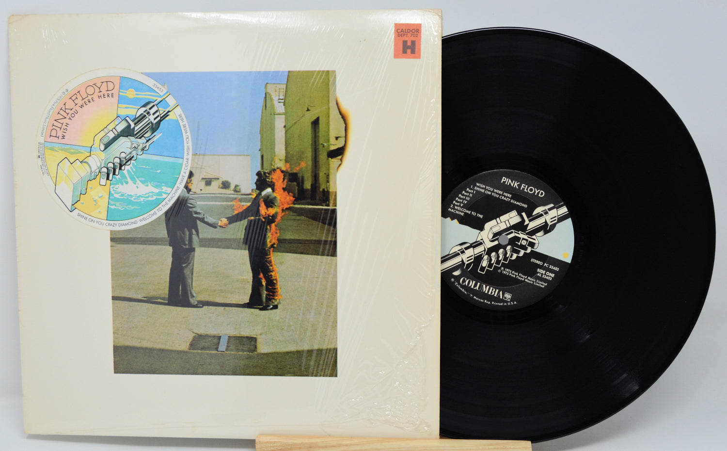 Vinyl record and cover with artwork of two figures holding hands and a spaceship.