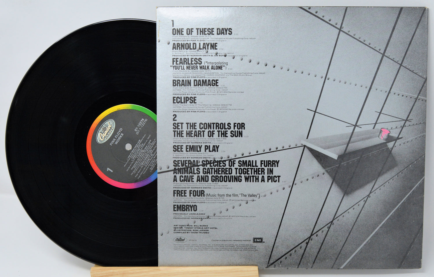 Vinyl record with cover featuring a person by a waterfront, on a white background