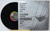 Vinyl record with cover featuring a person by a waterfront, on a white background