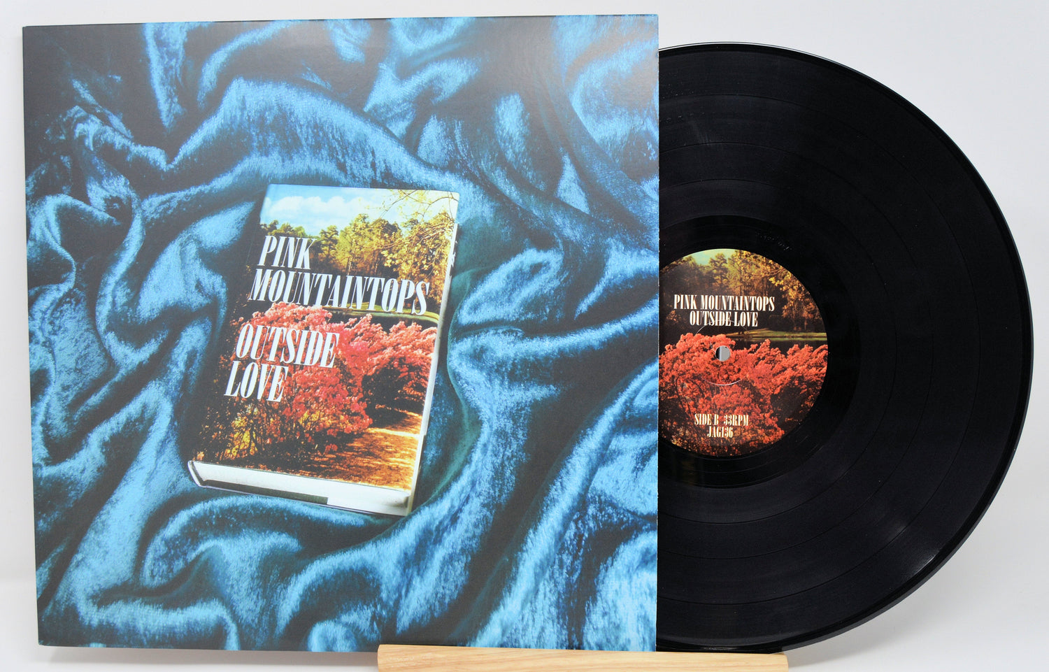 Front cover and vinyl record of Pink Mountaintops' Outside Love with bold floral artwork