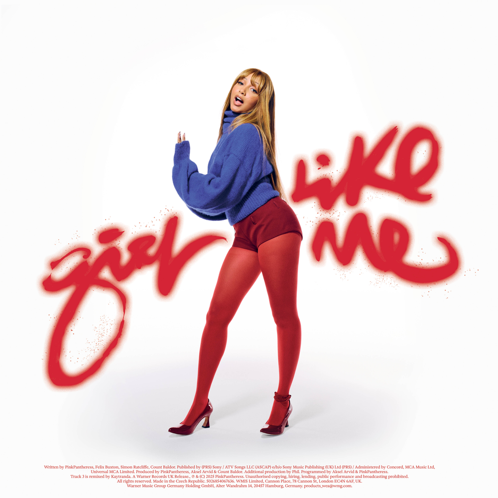 Woman in blue sweater and red shorts with 'Girl Like Me' text on a white background