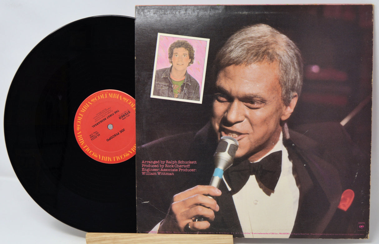 Vinyl record with cover featuring a man singing into a microphone