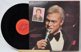 Vinyl record with cover featuring a man singing into a microphone