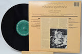 Vinyl record with a black cover and a yellowed sleeve featuring text and a photo of two people.