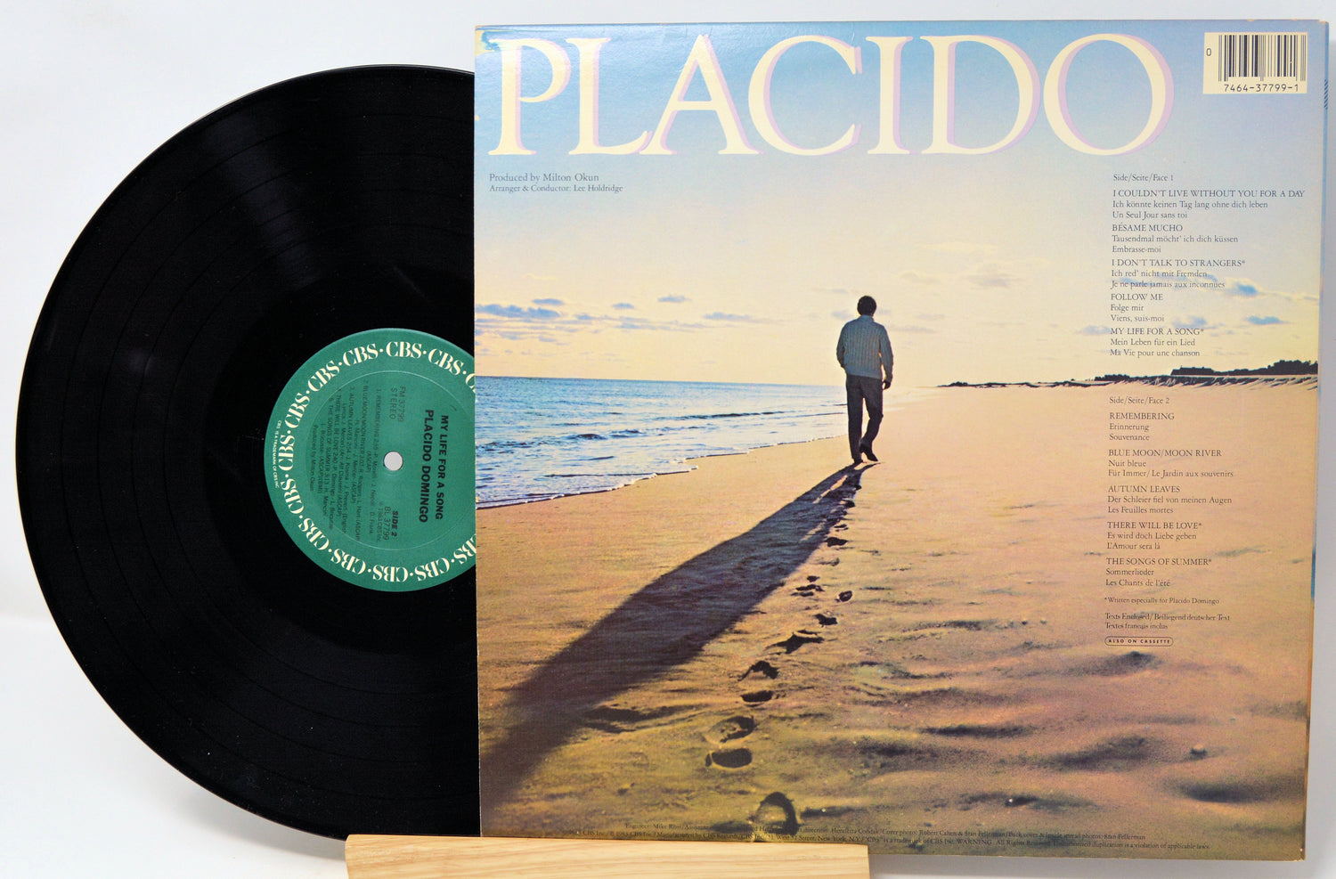 Vinyl record with a cover featuring a person walking on a beach