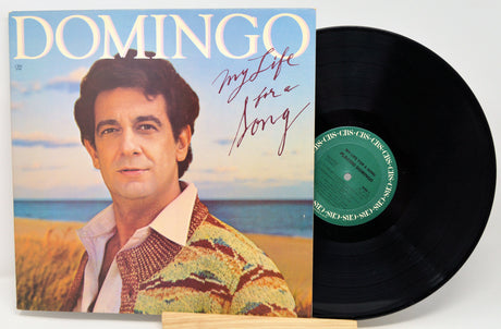 Vinyl record with cover featuring a man and ocean scene, titled 'Domingo My Life is a Song'.