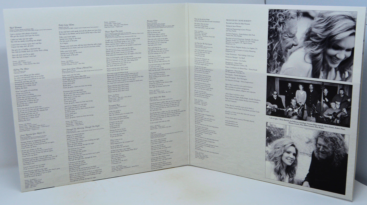 An open vinyl record sleeve or booklet showing printed track listings and three black-and-white photographs on the right page, photographed against a plain light background.