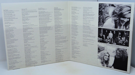 An open vinyl record sleeve or booklet showing printed track listings and three black-and-white photographs on the right page, photographed against a plain light background.