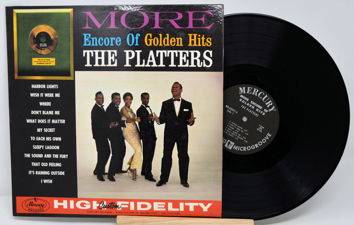 Vinyl record with cover featuring The Platters and text 'More Encore of Golden Hits'.